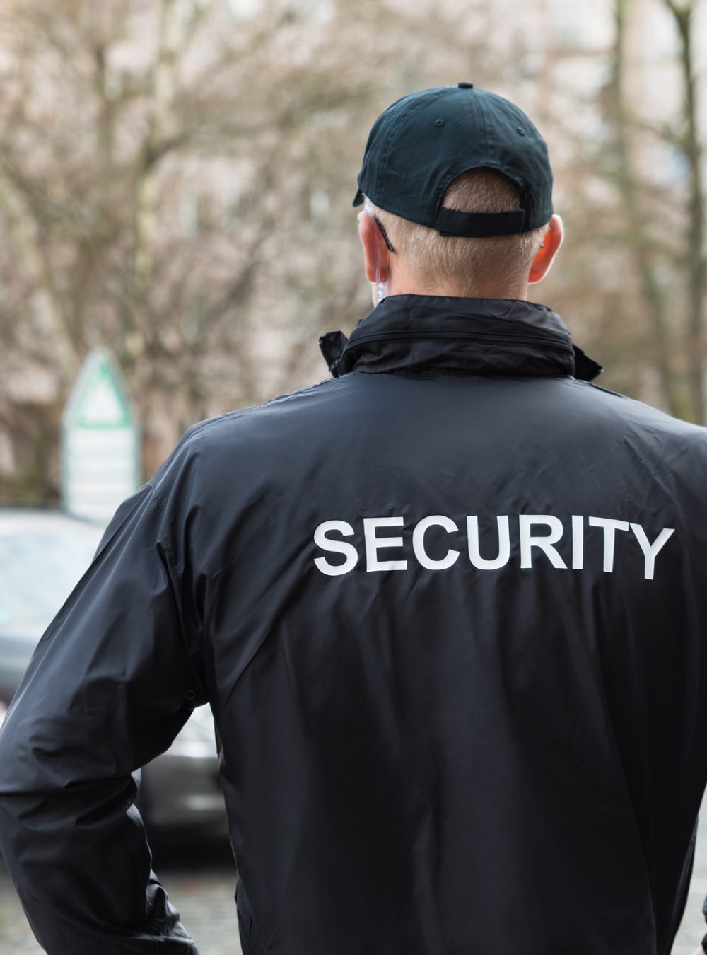 Close-up Of Male Security Guard Wearing Black Jacket